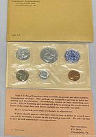 Front view of the 1963 US Mint Philadelphia proof coin set in original yellow envelope showing all coins sealed in cellophane.