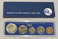 Front view of 1966 US Special Mint Set in plastic case, showing five uncirculated coins and blue cardboard sleeve with markings.