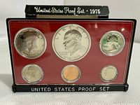 Front view of the 1975 US proof set showing six coins in plastic casing with red background and black borders with white text.