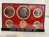 Front view of the 1976 US Bicentennial proof coin set in plastic case showing all six coins on red background
