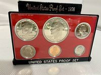 Front view of 1976 US Bicentennial Proof Coin Set in original plastic casing with six proof coins displayed on red background and black frame