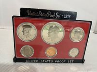 Front side view of six proof coins in plastic case with red insert and black base labeled United States Proof Set 1976
