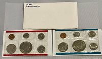 Two 1978 U.S. Mint uncirculated coin sets and white envelope with age wear