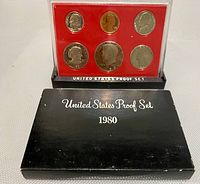 Front view of 1980 United States Proof Coin Set in black box and red background plastic casing displaying six coins.