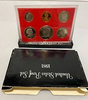 Plastic case holding the six 1981 US proof coins with a red background insert, front view.