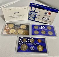 Photo showing the 2008 US Mint Proof Set box, certificate of authenticity, a set of 6 state quarters in plastic case, and a set of 4 presidential dollar coins in plastic case on a white surface.