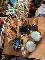 Overview of the lot showing all items including wicker chairs, Limoges bowls, the cheese dome, Disney bowl, and bookends.