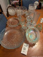 Overview of all serving dishes on table showing variety of shapes and sizes in clear textured ice glassware