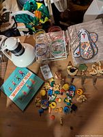 Overview photo of all items showing the sex-ed book, magnets, placemats with chicken design, thermos, and plastic glasses in caddy