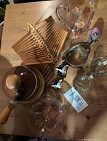 Photo showing Levanco fondue pot, MCM folding fruit basket, salt and pepper mice, clear glass pitcher with colorful fruits, small glassware including Disaronno glass, and small figurines.