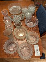 Overview photo of all glass serving dishes and candleholder displayed on table