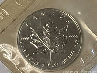 Front side of the 1994 Canadian Silver Maple Leaf coin showing maple leaf and purity markings.