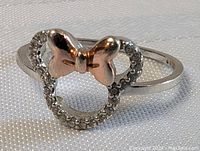 Close-up photo of sterling silver Minnie Mouse ring with crystal outline and rose gold-tone bow showing front detail