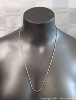 Full view of the sterling silver twisted chain necklace displayed on a black mannequin bust to show length and general appearance.
