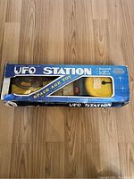 Full view of the original box showing branding, condition, and included toy inside