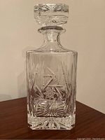 Full view of the vintage cut glass whiskey decanter with stopper, showing its overall shape and intricate cut glass design.