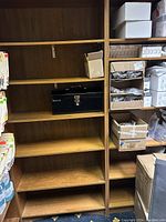 Four wooden bookcases with multiple shelves, shown containing various office folders and storage boxes (contents not included in lot).