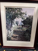 Framed painting showing a stone stair pathway with lush greenery and white lighthouse in the distance, detailed and realistic style