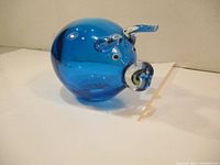 Blue art glass pig figurine showing rounded body and snout detail