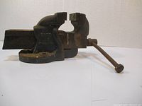 Side view of Old Henry metal bench vice showing the screw handle and jaws.