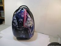 Front view of Star Wars hard shell case showing Darth Vader, stormtroopers, and red lightsaber graphic.