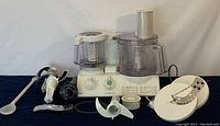 Full view of Braun CombiMax 750 food processor with various attachments and blades laid out in front showing included items.