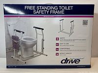 Front view of boxed Drive Free Standing Toilet Safety Frame showing product on toilet with key features listed on box.