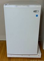 Front view of the closed white Marathon small fridge showing smooth door surface and Marathon logo.
