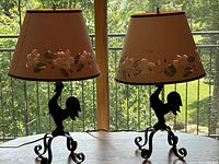 Both lamps with shades installed, shown on a table against window