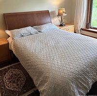 Full assembled bed with bedding in room