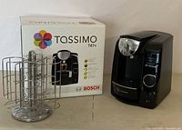 Overview of the coffee maker, pod carousel, and original box displayed together