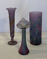 Overall view of three Rueven Glass vases showing their shapes and color patterns