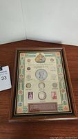 Framed Canadian coinage collection of Elizabeth II 1952 shown fully assembled on wood surface.