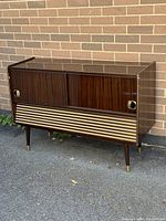 Full view of vintage Telefunken wooden console stereo player with dark wood finish and sliding doors.