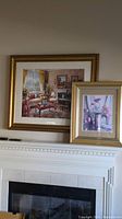 Two framed prints on a white mantel, one large with a living room scene, one smaller with pink flowers