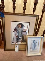 Framed prints displayed resting on staircase carpet; shows overall lot with two prints together.