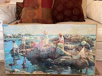 Front view of signed and numbered print showing a group of people on rocks by water, framed in wood.