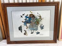 Framed Norman Rockwell reflective print showing boy, girl, and animals with wood frame.