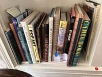 Photo showing a shelf of assorted books including titles on pop art, gardening, foreign languages, and travel.