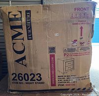 Photo of the shipping cardboard box with ACME Furniture branding, item number 26023, indicating nightstand inside.