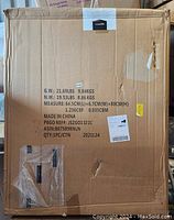 Original large cardboard box for Amazon Basics metal pet exercise fence pen. Box shows product details, weight, and dimensions.