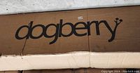 Close-up of cardboard box with 'dogberry' brand name printed in large black letters on top.