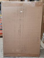 Photo of the cabinet boxed in plain cardboard packaging showing its original shipping condition.