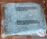 Photo of three-piece bath rug set in original sealed plastic packaging, light blue color.