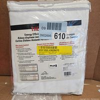 Packaged curtain panel in clear bag with label showing product details and energy efficiency info.