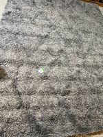 Full view of the rectangular shaggy area rug showing the blue and gray subtle geometric pattern.