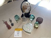 Collection of vintage glass and crystal decorative items displayed on a table, showing the full lot from above with natural light.