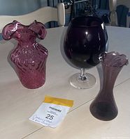 Photo showing the cranberry purple textured vase, large purple goblet, and smaller purple bud vase on a light table.