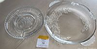 Top view of oval and round crystal plates side by side on floor with a MakSold tag