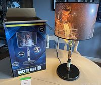 Doctor Who lamp displayed on a table with original box alongside. Shows lamp in detail and packaging.